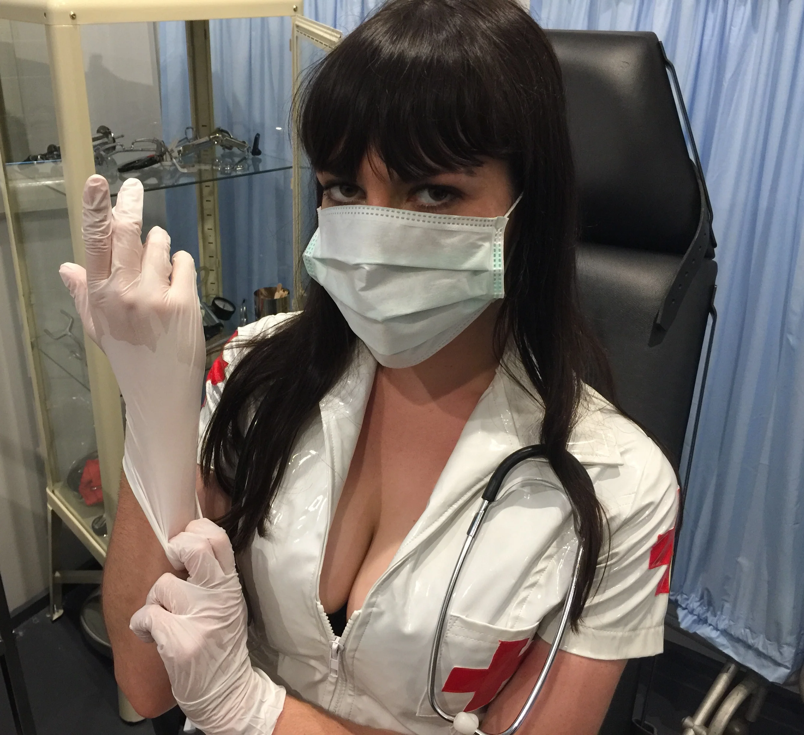 Seraphine Melbourne ProDomme in latex nurse roleplay with medical gloves — professional dominatrix BDSM session